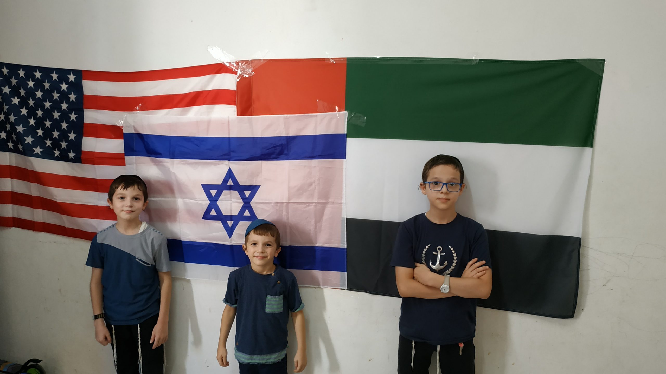 אילוסטרציה: ילדים ישראלים עם דגלי איחוד האמירויות ארה"ב וישראל